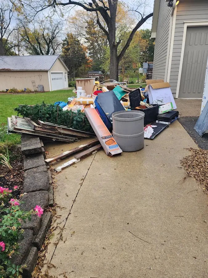 Dumpster being loaded with debris for 12 Yard Dumpster Rental in West Puente Valley